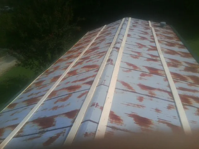 Rusted metal roof panels with new wood purlins before replacement — Storm Damage Roof Repair in Amador City by Roofing Brothers